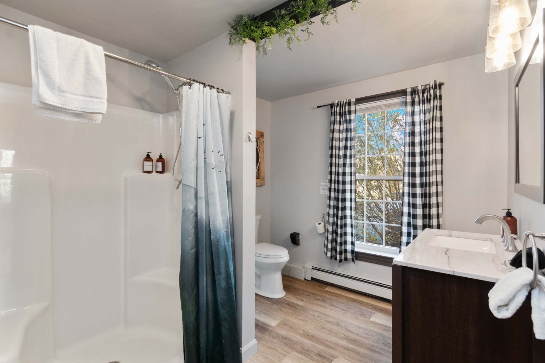 Long Trail Suite bathroom with shower, toilet, and vanity