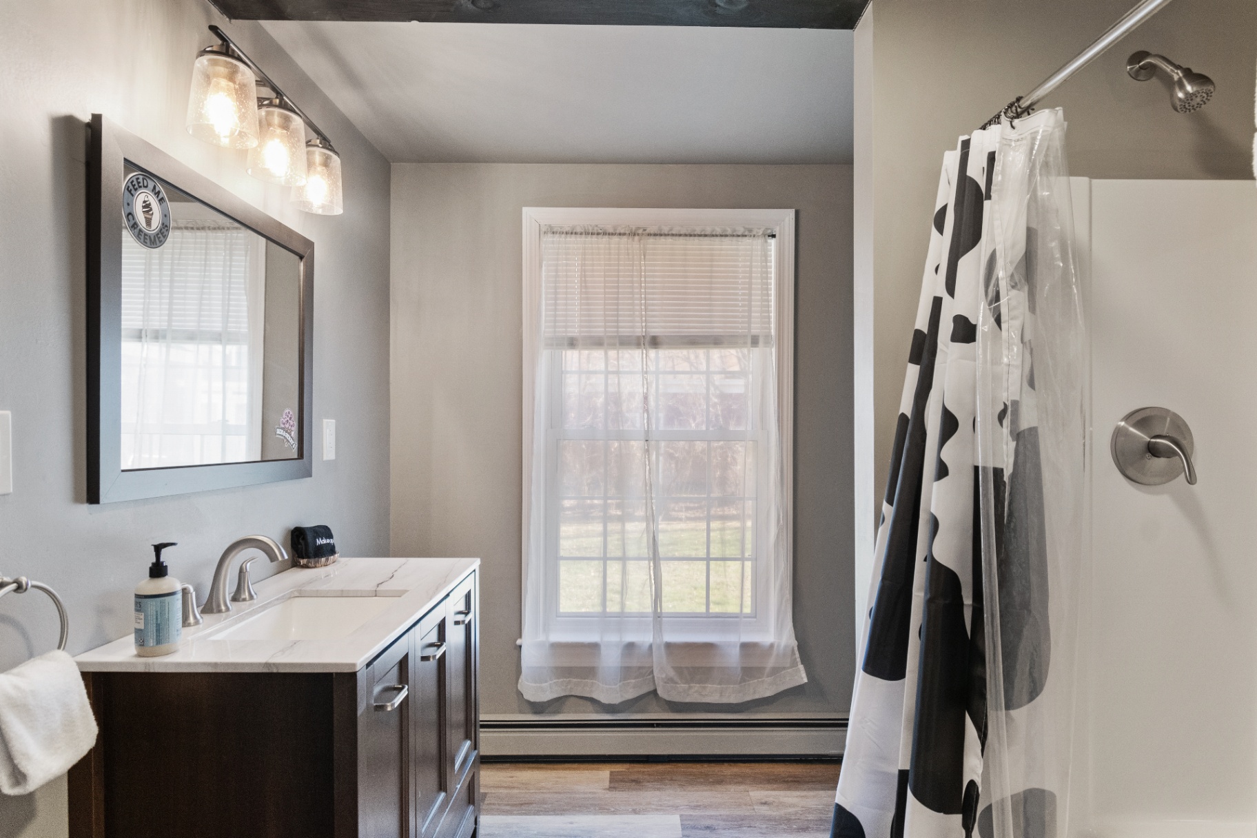 Bathroom with shower and large window