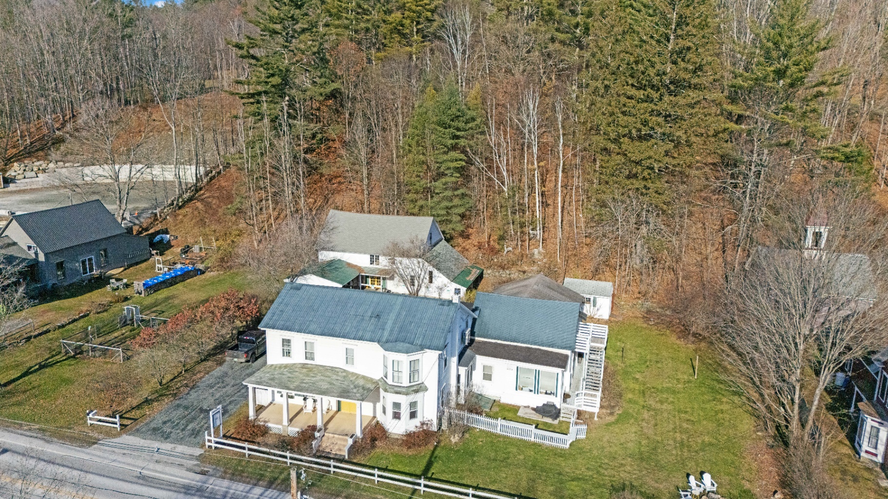 Aerial view of the historic Bridgewater Living property, main house and suites surrounded by Vermont woods