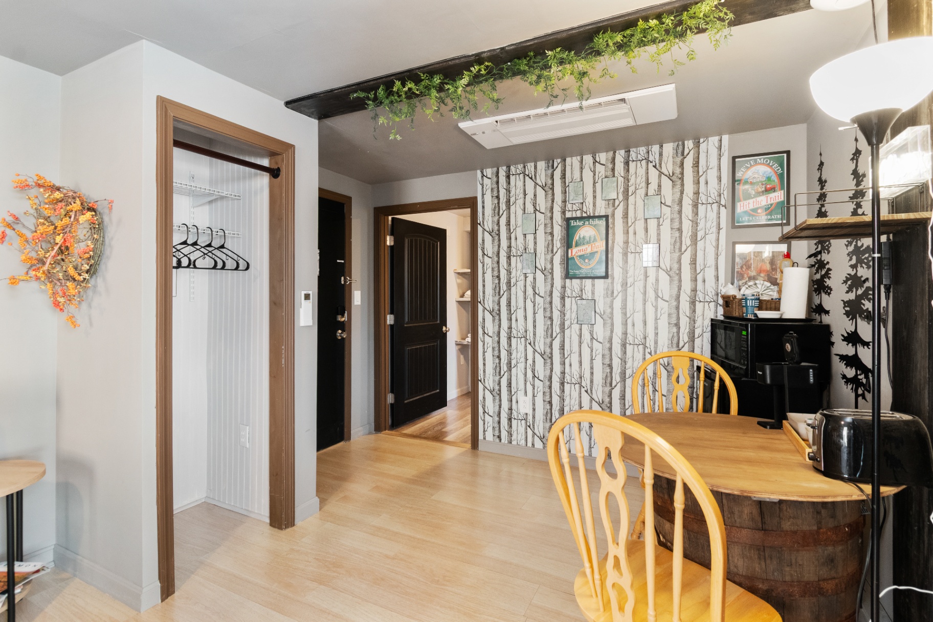 Dining table, closet, and entry area in the Long Trail Suite
