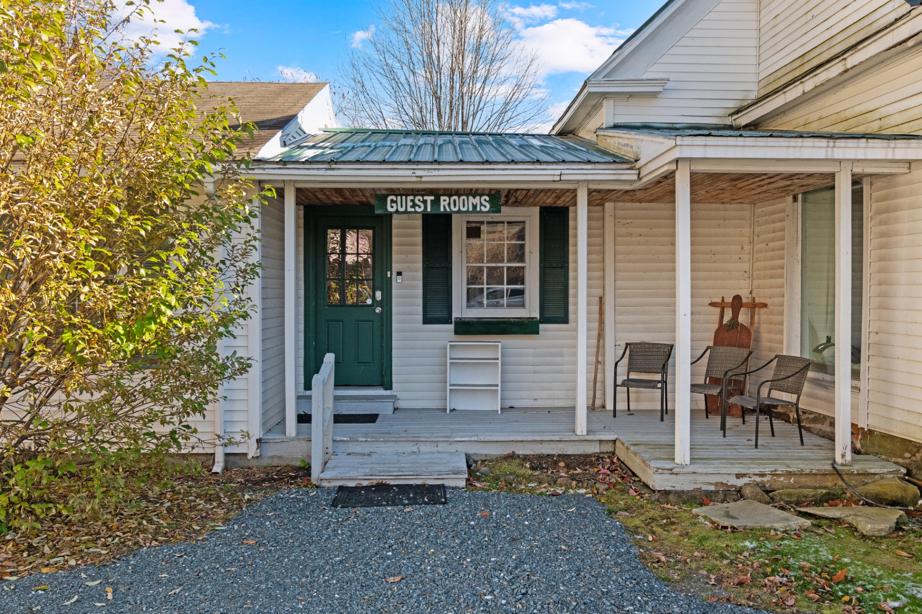 Guest rooms entrance at Bridgewater Living with green door and vintage sign