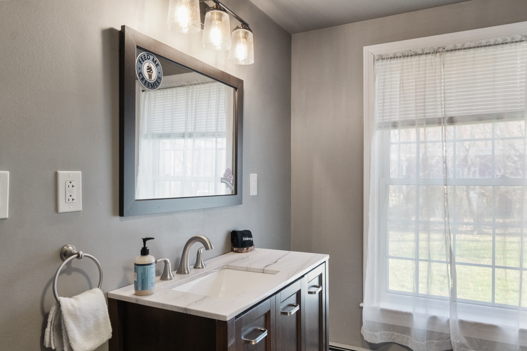 Renovated bathroom vanity with marble countertop