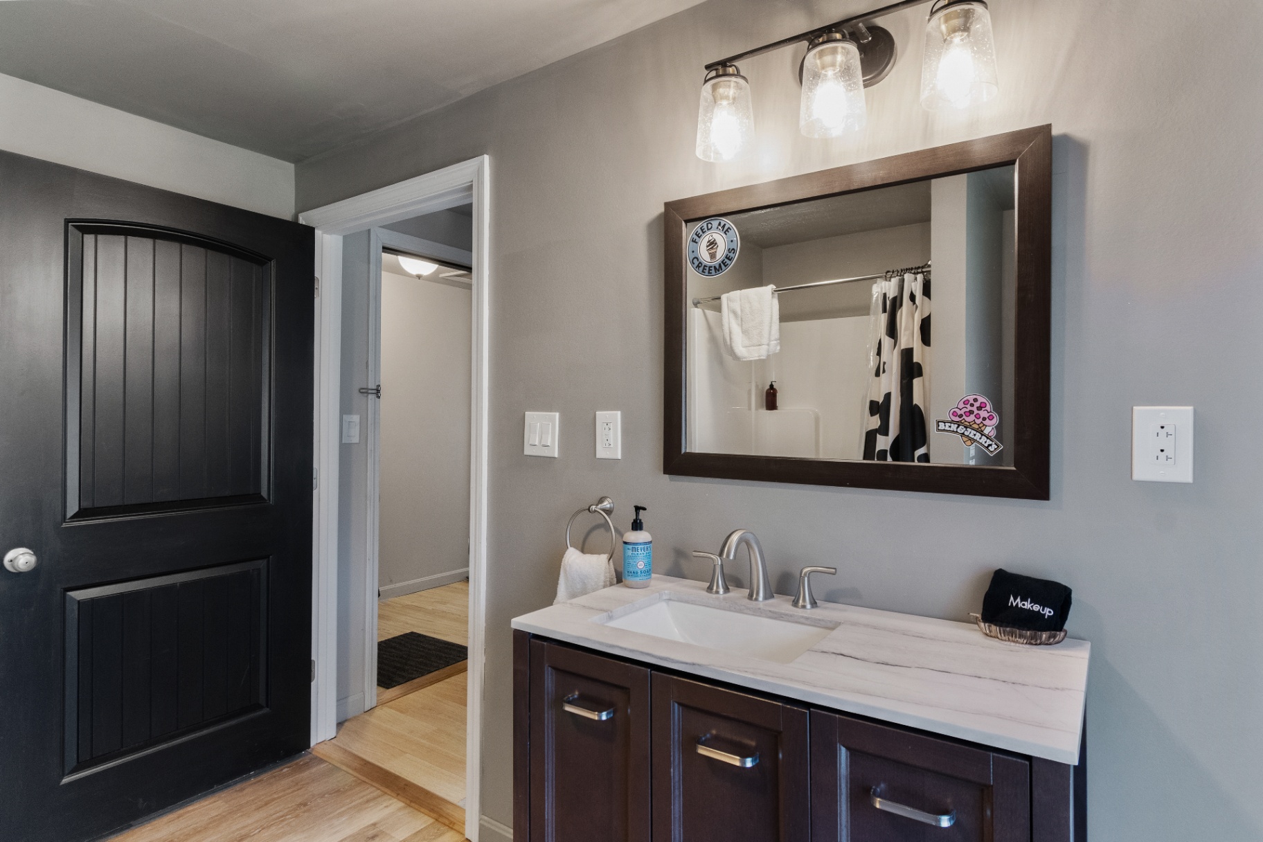 Bathroom vanity and mirror near entry