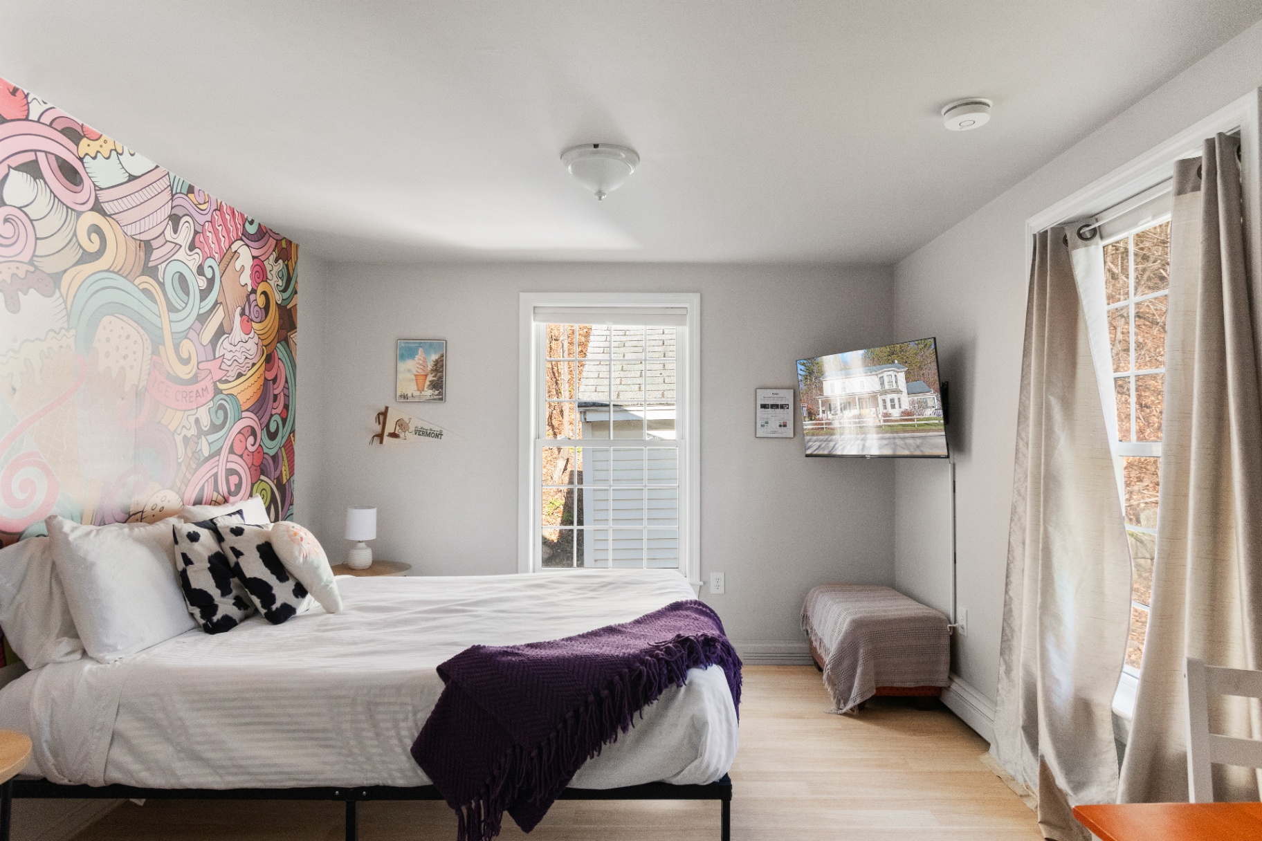 Bedroom with wall-mounted TV and natural light