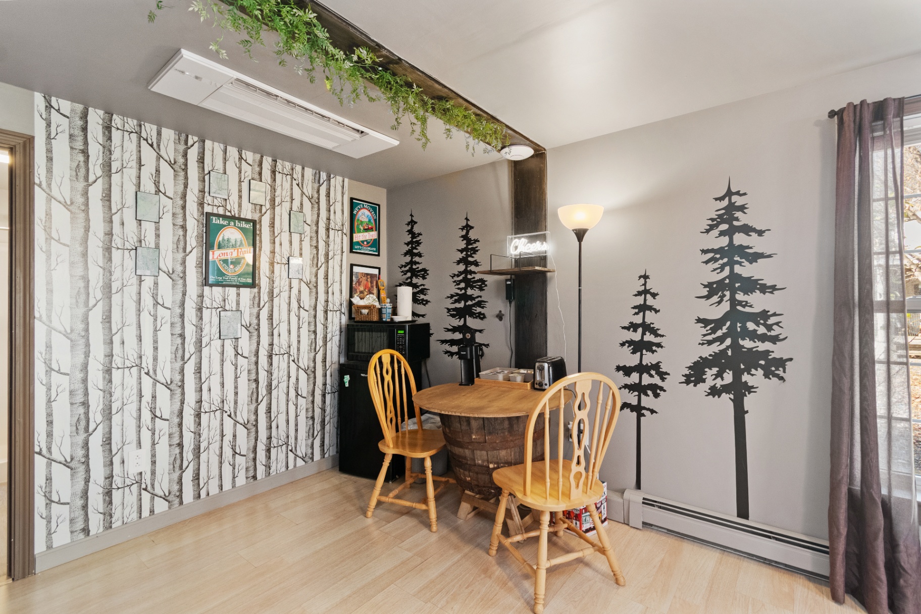 Dining nook with forest wall decor in the Long Trail Suite