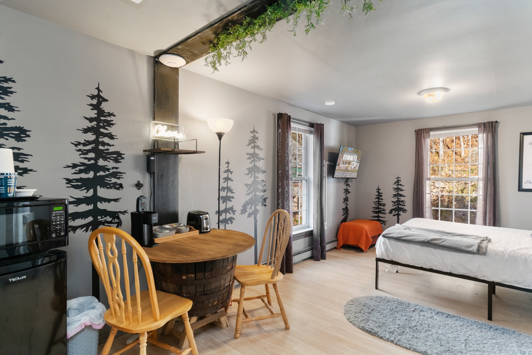 Wide view across the Long Trail Suite from the dining area toward the bed