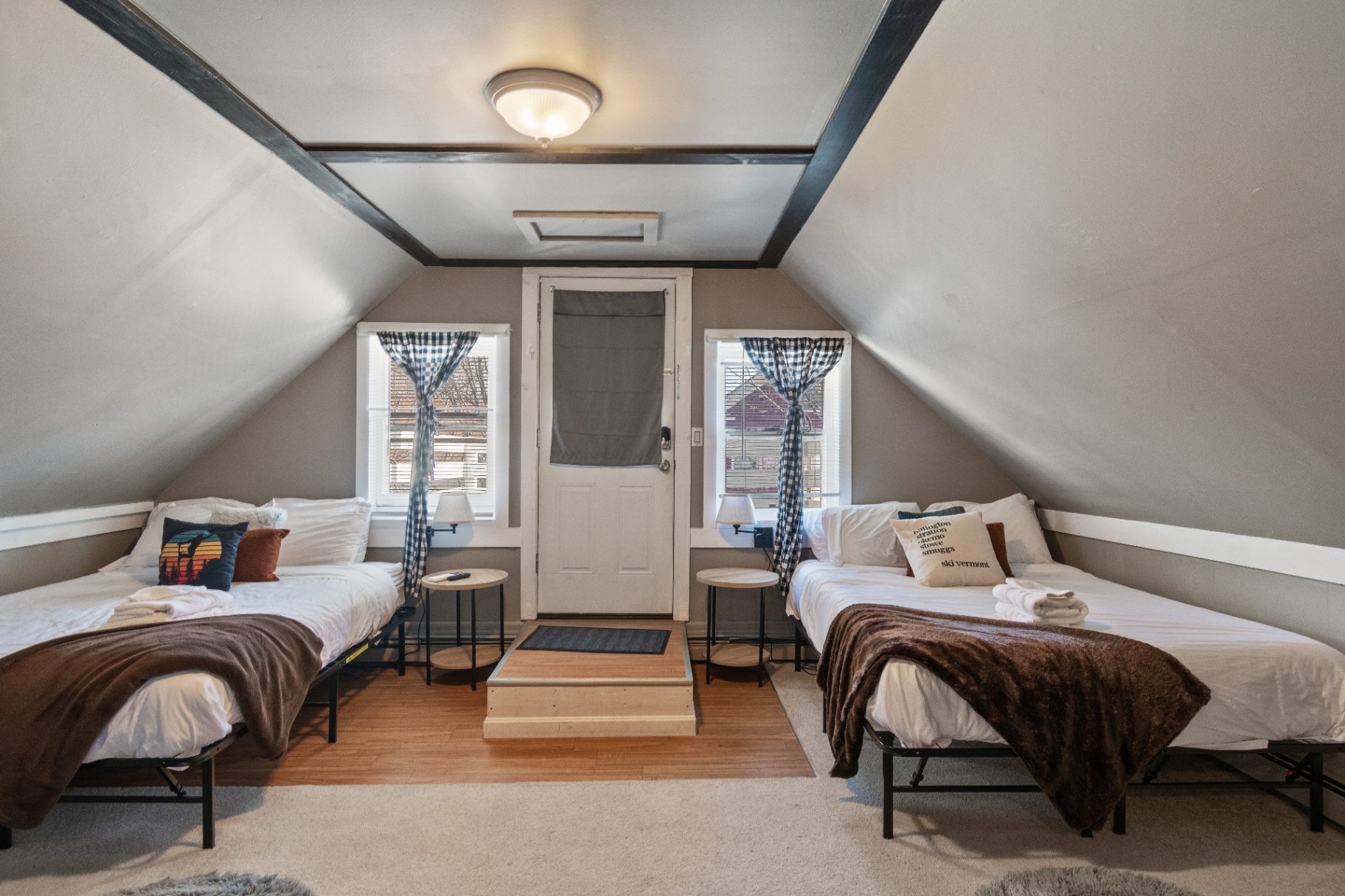 Symmetrical twin beds under attic ceiling